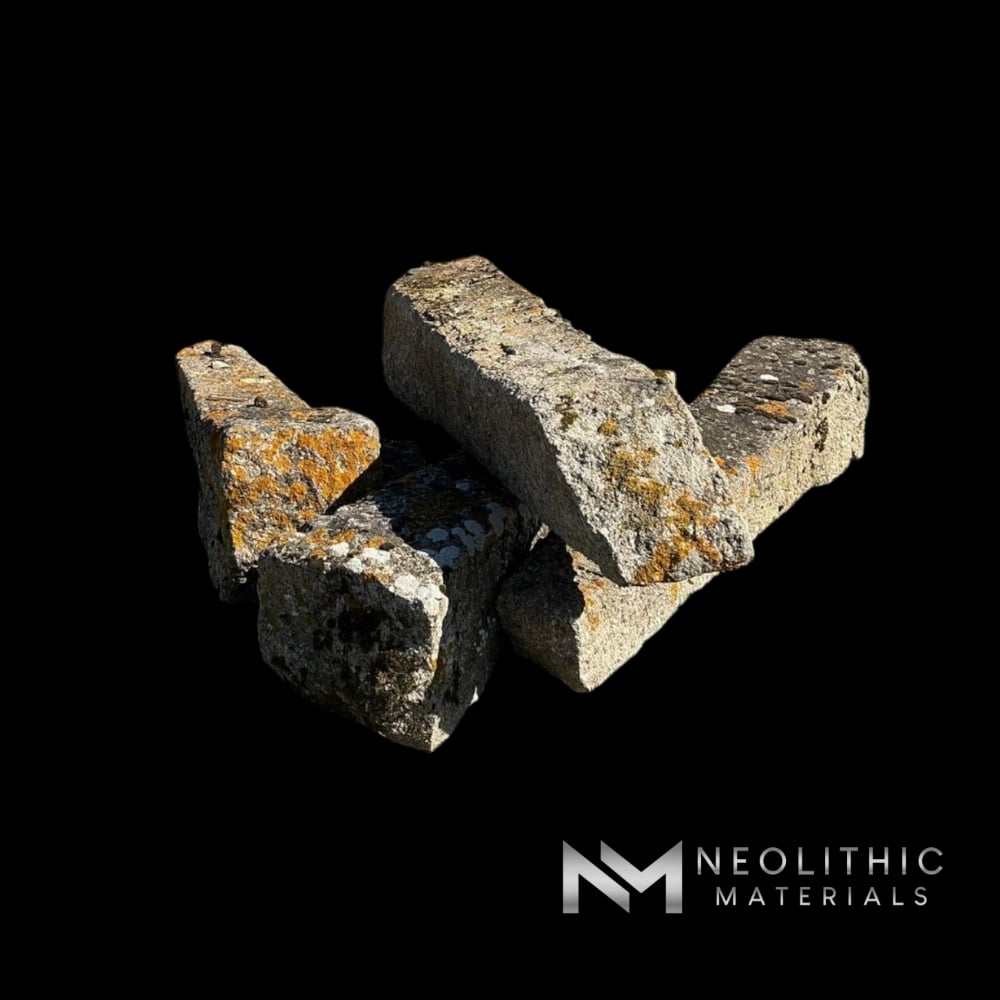 Miscellaneous FG105-14 to FG105-17 rough-hewn salvaged antique stone architectural fragments and landscape pillars arranged in an outdoor display yard under a blue sky.