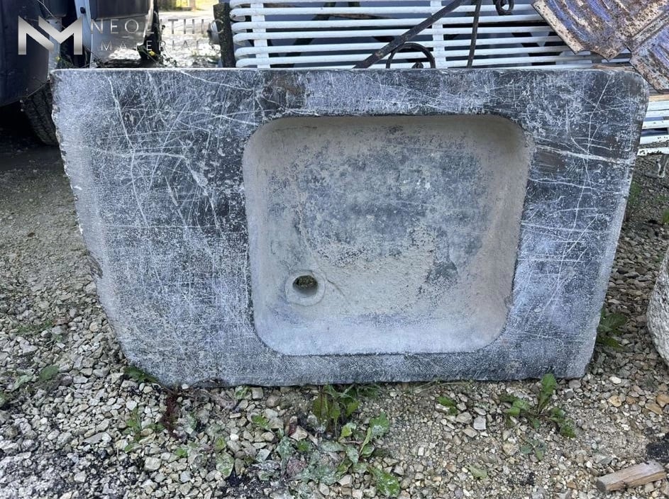 Sink FK104-05 heavy rustic stone utility basin featuring weathered gray markings and an integrated wash well set against a gravel backdrop.