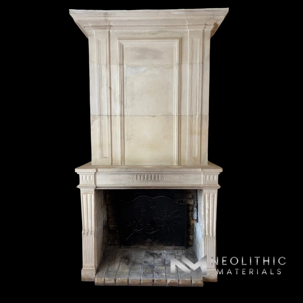 Fireplace Mantel FS101-01.EY: Vertical interior photography highlighting an elegant antique carved marble fireplace mantle showcasing refined linear moldings, paired with its matching floor-to-ceiling trumeau hood section over a dark cast iron hearth.